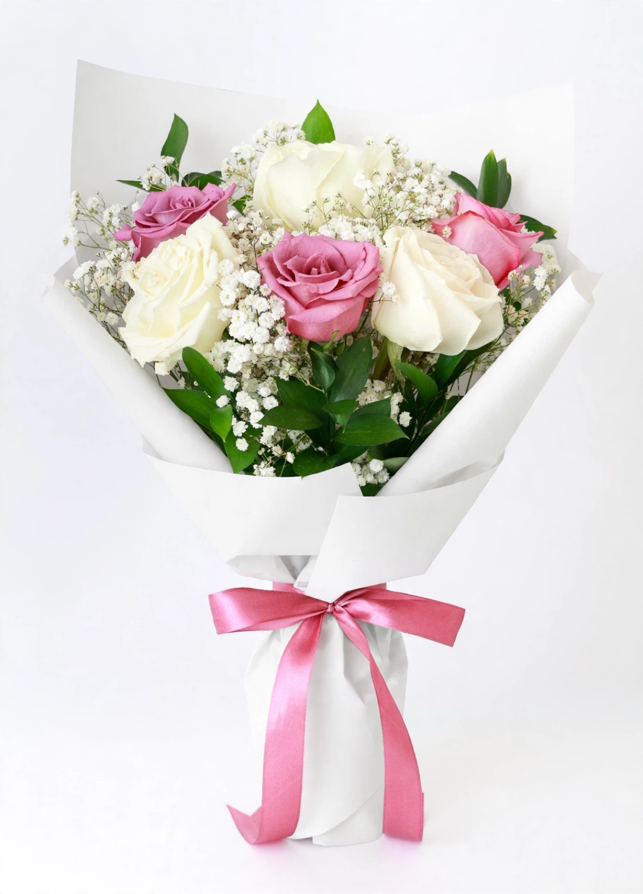 Style example for The Petite — white, pink, and purple roses with baby's breath in white wrap tied with a pink satin bow